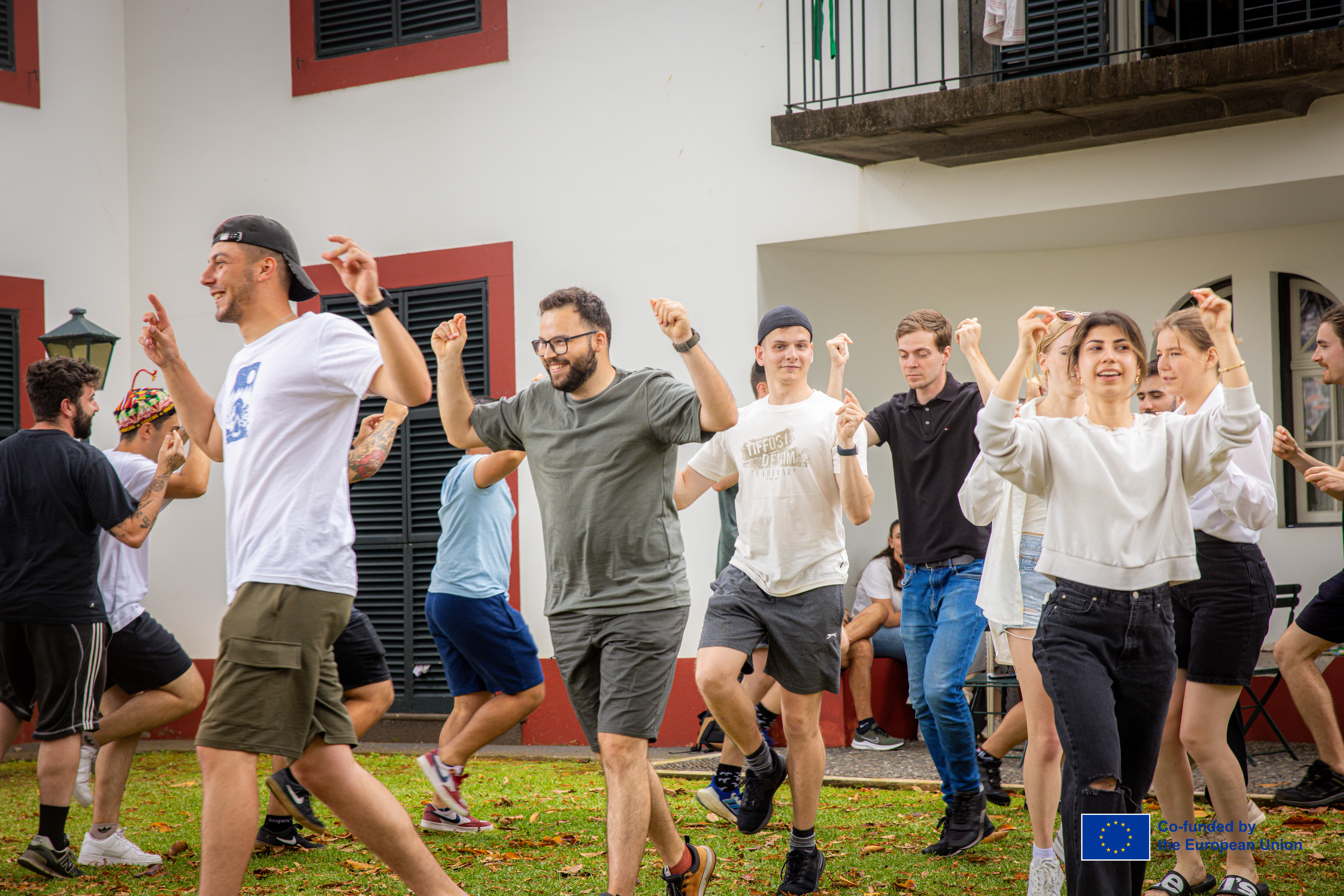 Young people performing a group dance outdoors in Madeira.
